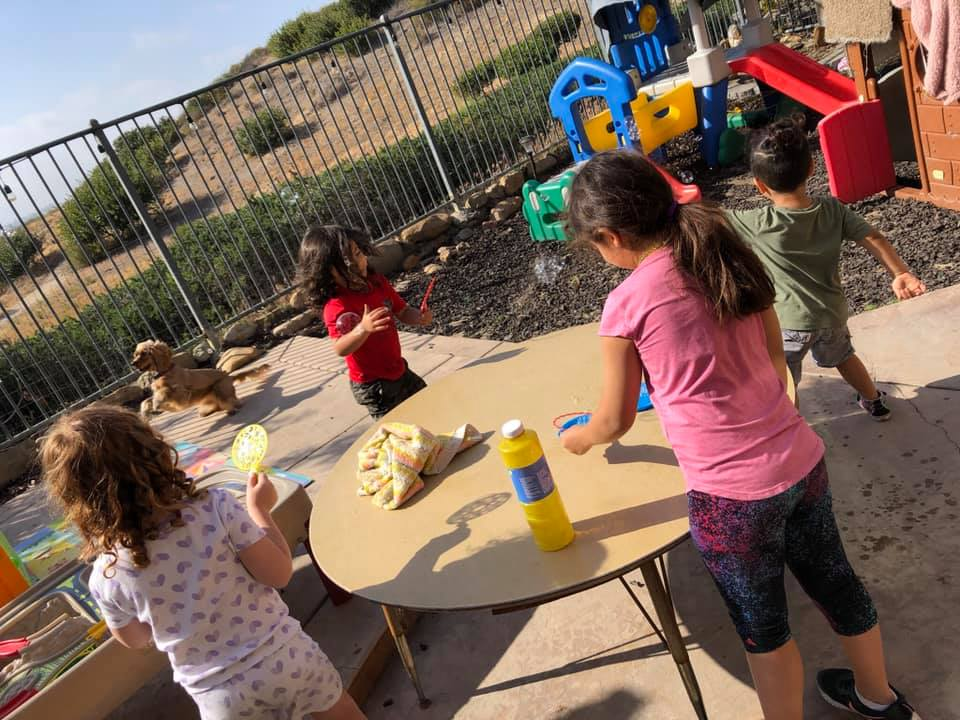 Children playing with bubbles during outdoor time